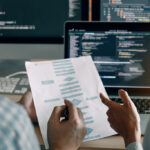 Developing programming and coding technologies working in a software engineers developing applications together in office.
